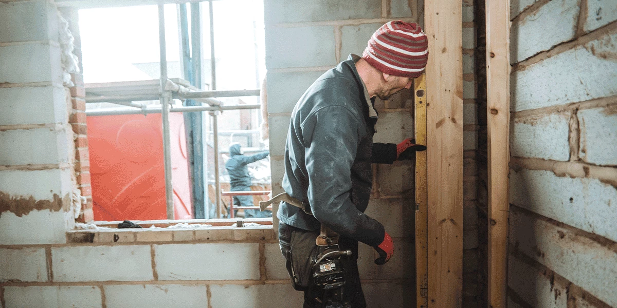 worker on site checking level