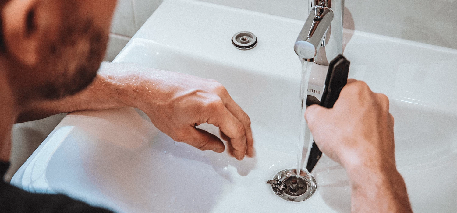 plumber looking working on sink